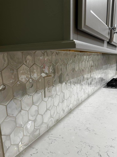 Aqua marble kitchen backsplash with vivid blue veining over white quartz countertops