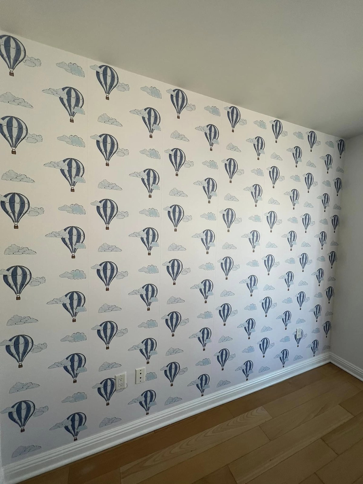 Hot air balloon wallpaper installed in a nursery by Jeff Handyman