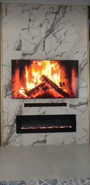 Modern fireplace and TV accent wall with stone surround installed by Jeff Handyman