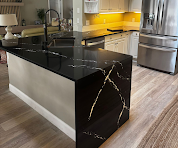 Black marble waterfall kitchen island with yellow subway tile backsplash
