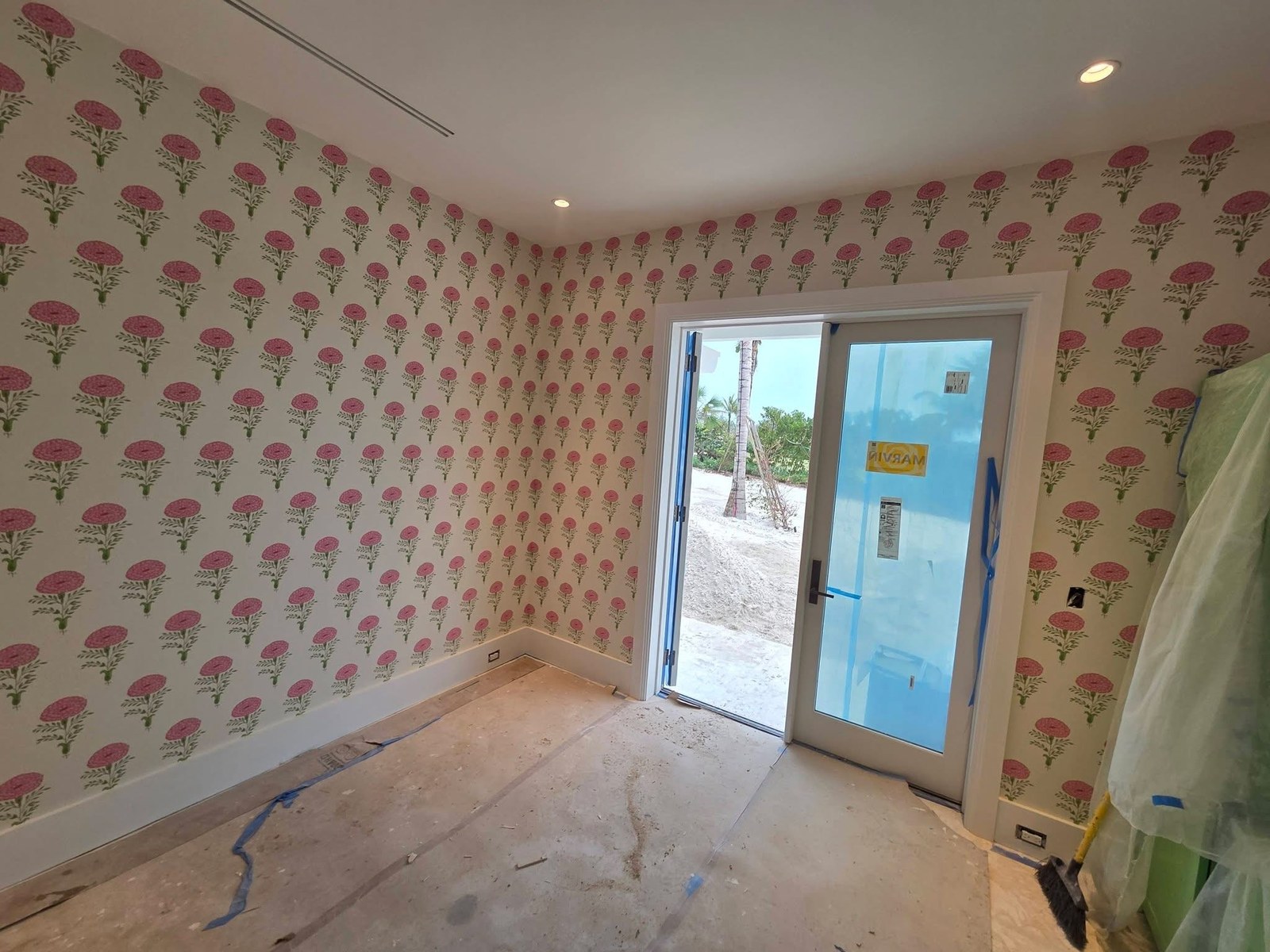 Pink poppy floral wallpaper installed by Jeff Handyman in a bright entry room