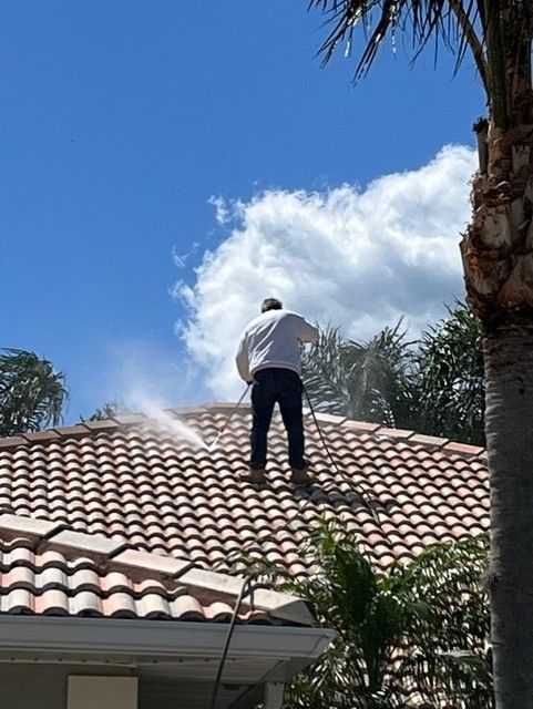 Pressure washing a Florida tile roof to remove mildew and stains