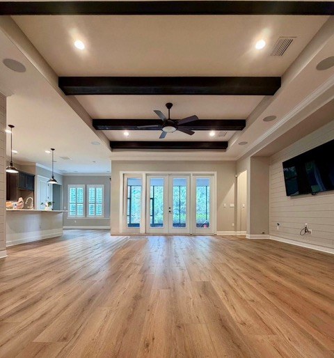 Wide-plank luxury vinyl floor with crystal chandelier and open layout install by Jeff Handyman