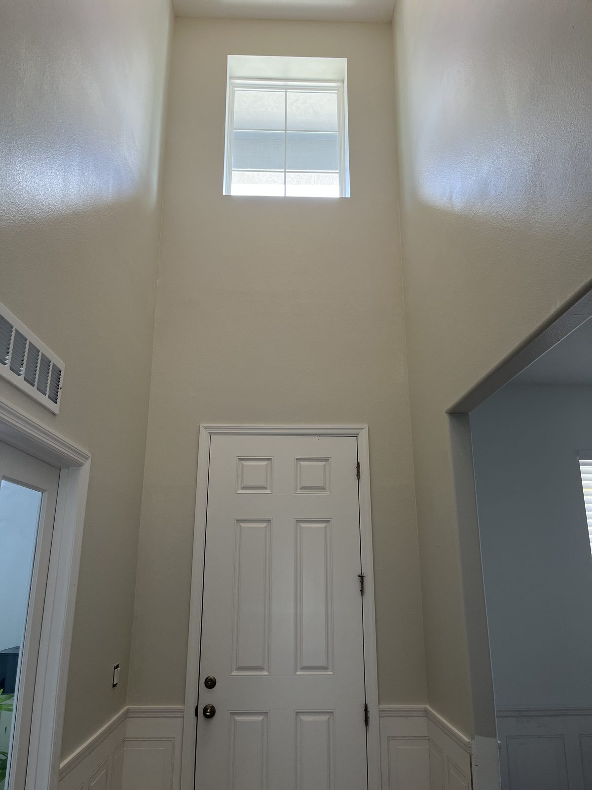 White exterior front door with frosted sidelight glass panels